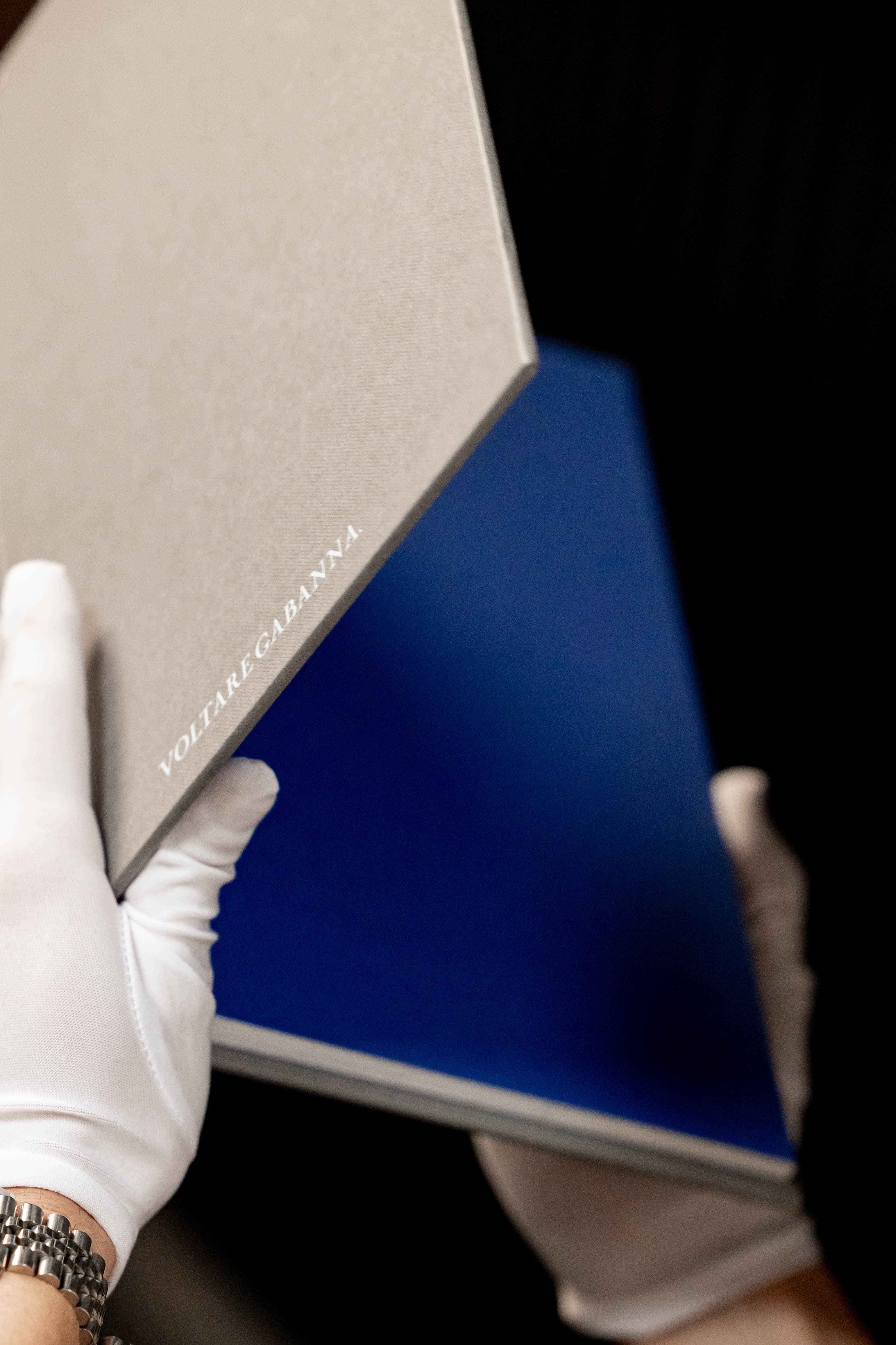 Opening the dove grey album to reveal blue interior