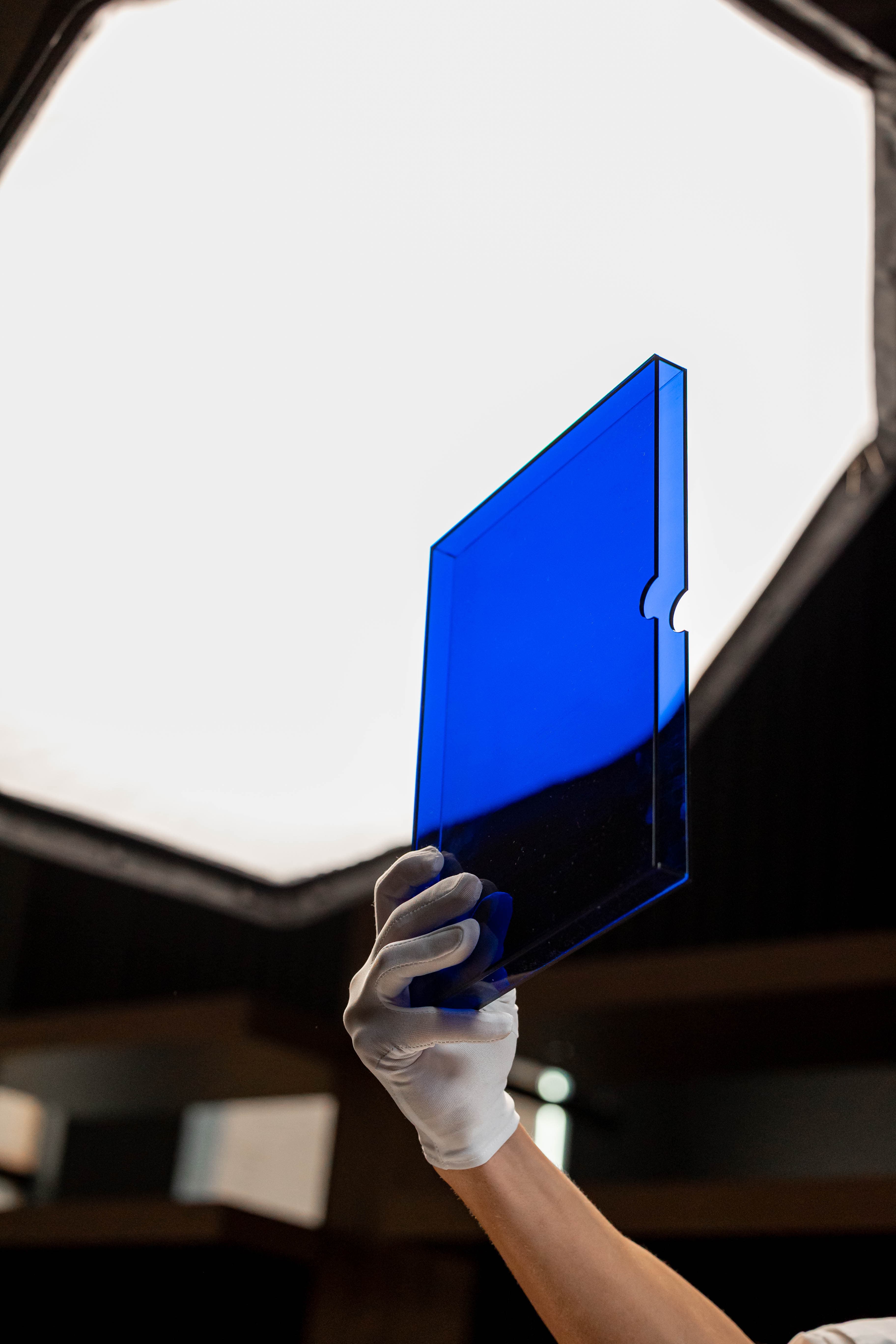 Royal blue perspex presentation box held up to light